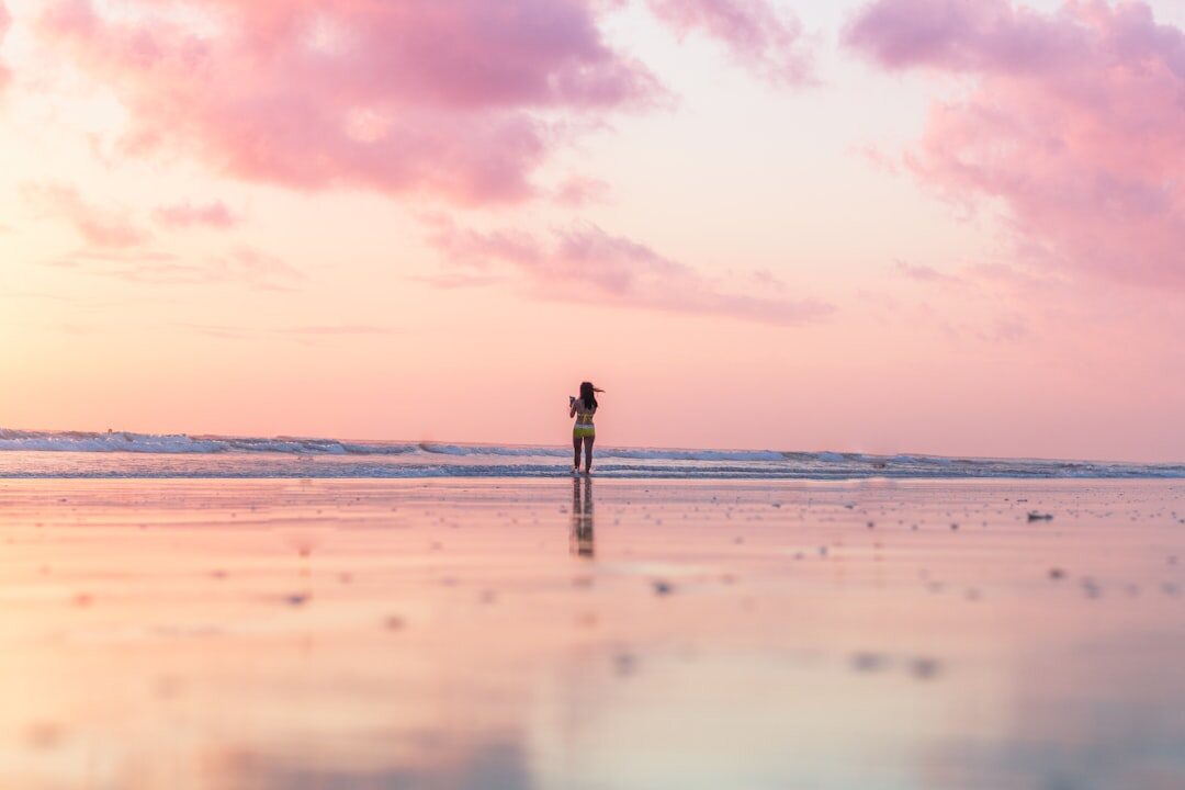 woman walking alone on beach